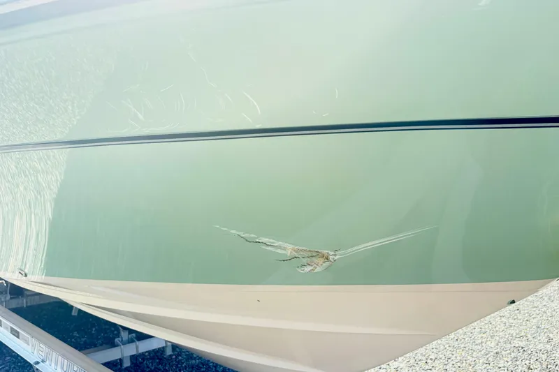 Slide: The Image of 2022 Grady-White 251 Coastal Explorer with hull damage on trailer. - 9