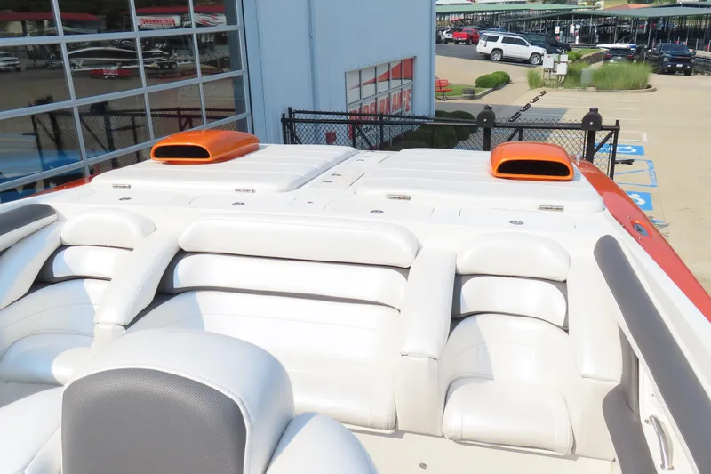 Slide: The Image of Luxury MTI 42 boat interior with white leather seating, orange accents, and modern design, 2003 model. - 11