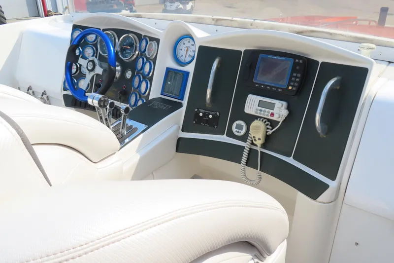 Slide: The Image of Cockpit of 2003 MTI 42 boat with steering wheel, gauges, and navigation equipment. - 12