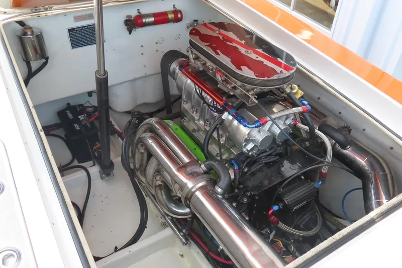 Slide: The Image of High-performance engine in a 2003 MTI 42 boat, featuring chrome components and vibrant detailing. - 17