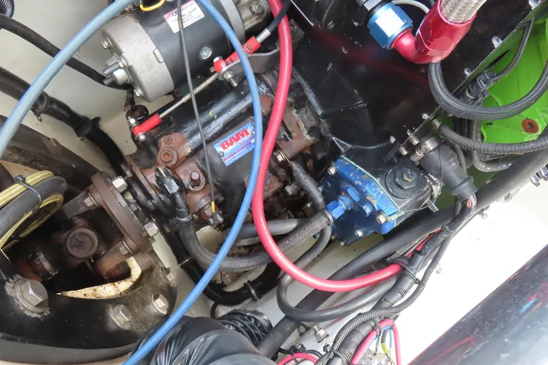 Slide: The Image of Engine components of a 2003 MTI 42 boat, featuring wires and mechanical parts. - 20