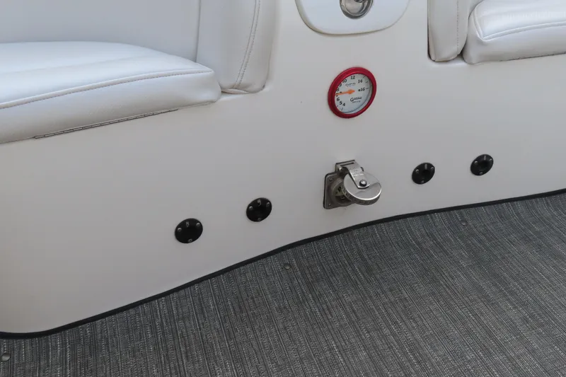Slide: The Image of Interior of a 2003 MTI 42 boat with white seating and gauge. - 22