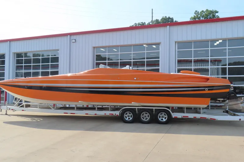 Slide: The Image of Orange MTI 42 speedboat on trailer, parked outside a building, 2003 model. - 26
