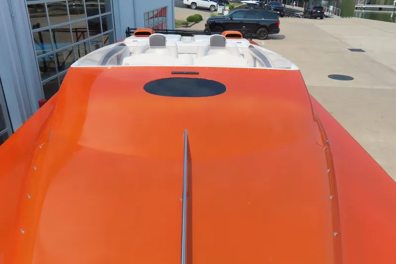 Slide: The Image of Orange MTI 42 speedboat, 2003 model, parked outside a building. - 27