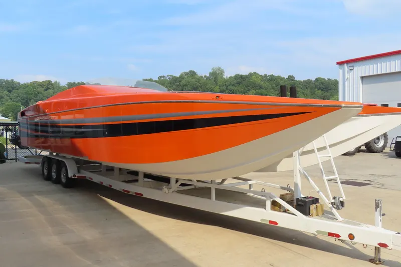Slide: The Image of Orange MTI 42 speedboat on trailer, 2003 model, parked outdoors. - 5