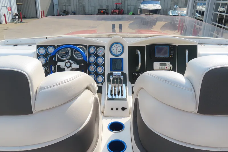 Slide: The Image of Cockpit of 2003 MTI 42 boat with gauges, steering wheel, and controls. - 9