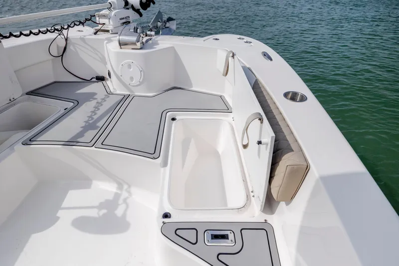 Slide: The Image of 2023 Twin Vee 240 GFX CC boat interior with storage compartments and seating. - 26