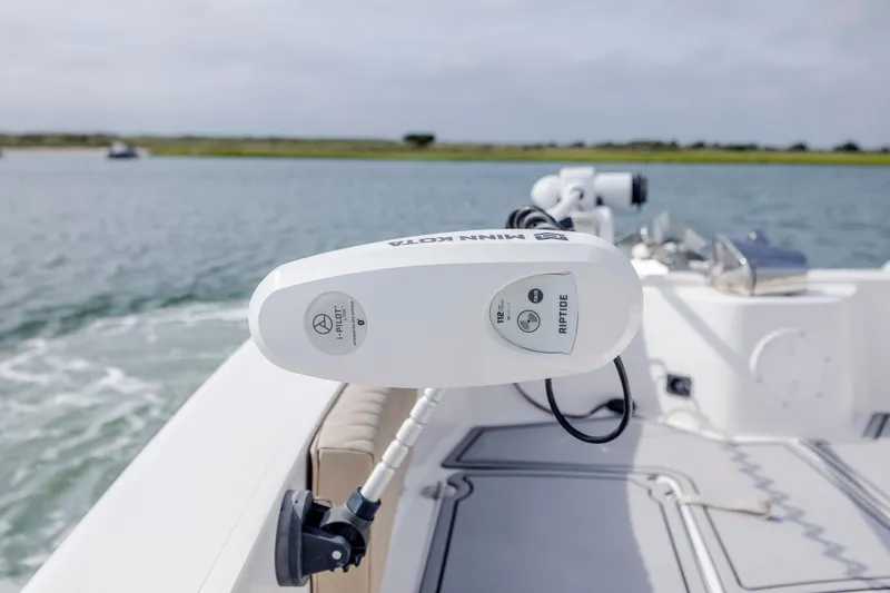 Slide: The Image of 2023 Twin Vee 240 GFX CC boat with Minn Kota trolling motor on calm water. - 27