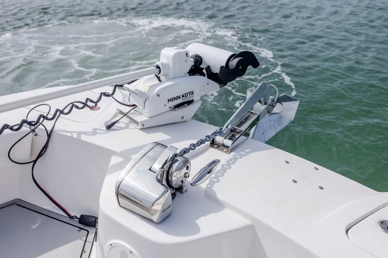 Slide: The Image of 2023 Twin Vee 240 GFX CC boat with Minn Kota trolling motor on water. - 28