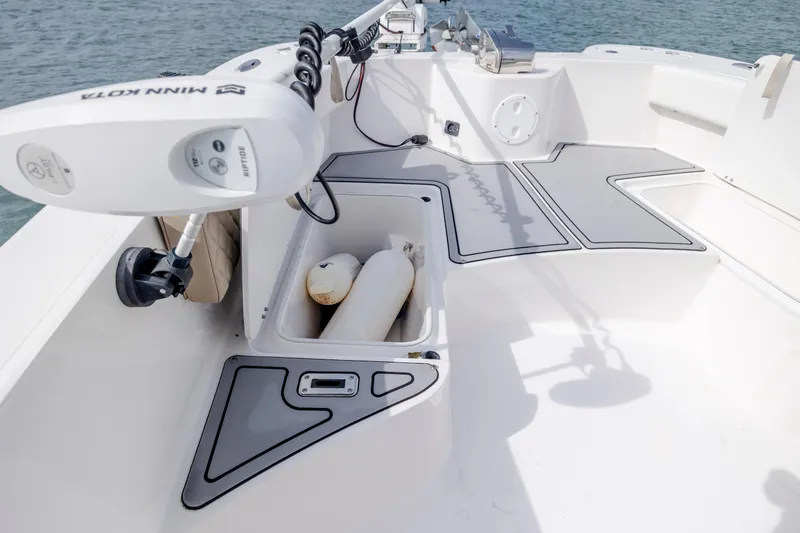 Slide: The Image of 2023 Twin Vee 240 GFX CC boat deck with storage compartments and motor. - 29