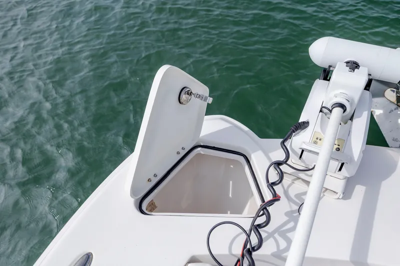 Slide: The Image of 2023 Twin Vee 240 GFX CC boat with open hatch and motor, on water. - 31