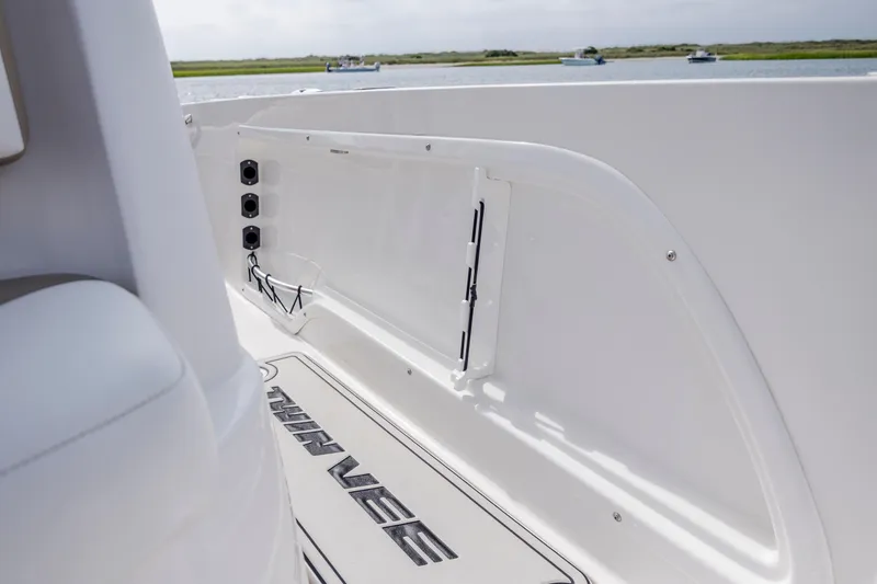 Slide: The Image of 2023 Twin Vee 240 GFX CC boat interior with sleek white design and logo. - 32