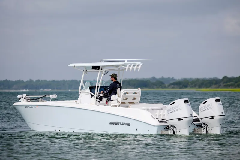 Slide: The Image of 2023 Twin Vee 240 GFX CC boat with triple Suzuki engines on water. - 6