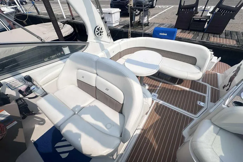 Slide: The Image of 2004 Four Winns 298 Vista boat interior with white seating and wooden flooring. - 10