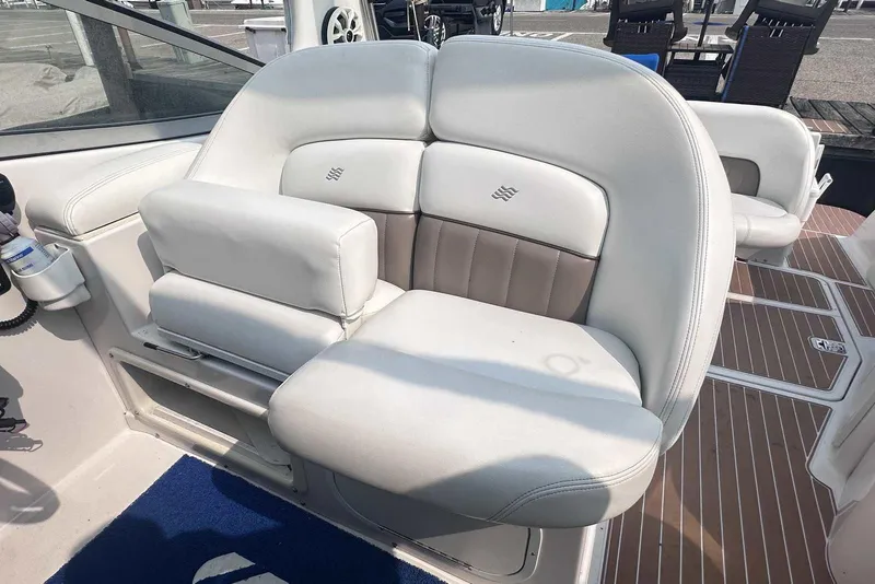 Slide: The Image of 2004 Four Winns 298 Vista boat interior with white cushioned seating. - 13