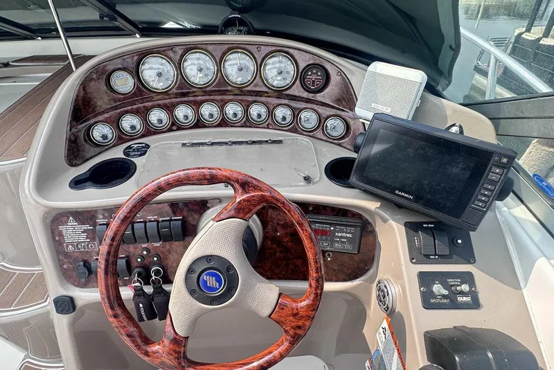 Slide: The Image of Dashboard of 2004 Four Winns 298 Vista boat with steering wheel and navigation instruments. - 15
