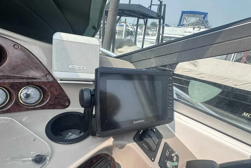 Slide: The Image of 2004 Four Winns 298 Vista dashboard with Garmin GPS and West Marine speaker. - 16