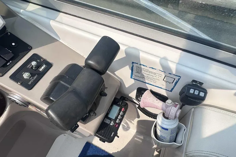 Slide: The Image of 2004 Four Winns 298 Vista boat cockpit with controls and communication devices. - 17