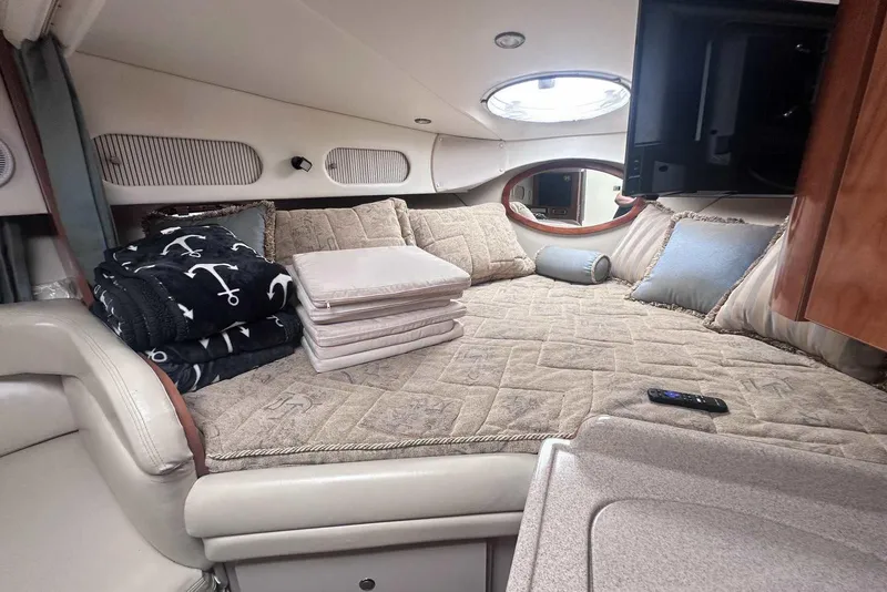 Slide: The Image of Luxurious cabin interior of 2004 Four Winns 298 Vista boat with cozy bedding and decor. - 24
