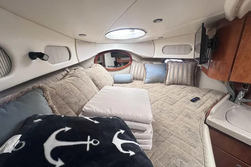 Slide: The Image of Interior of 2004 Four Winns 298 Vista boat with cozy bedding and nautical decor. - 25