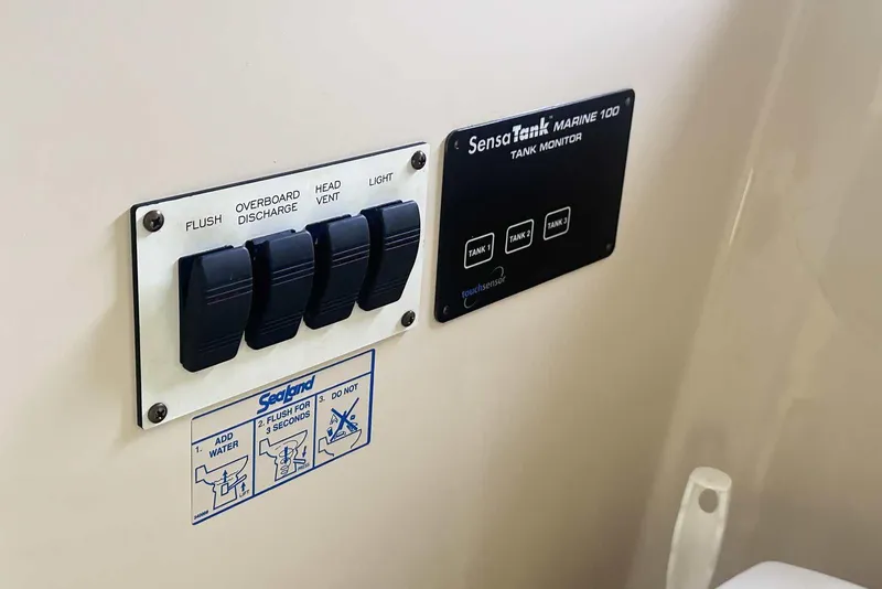 Slide: The Image of Control panel and tank monitor on 2004 Four Winns 298 Vista boat. - 28