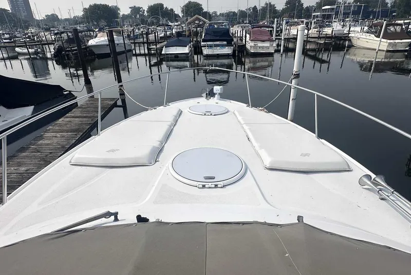 Slide: The Image of 2004 Four Winns 298 Vista boat docked at a marina, view from the bow. - 3