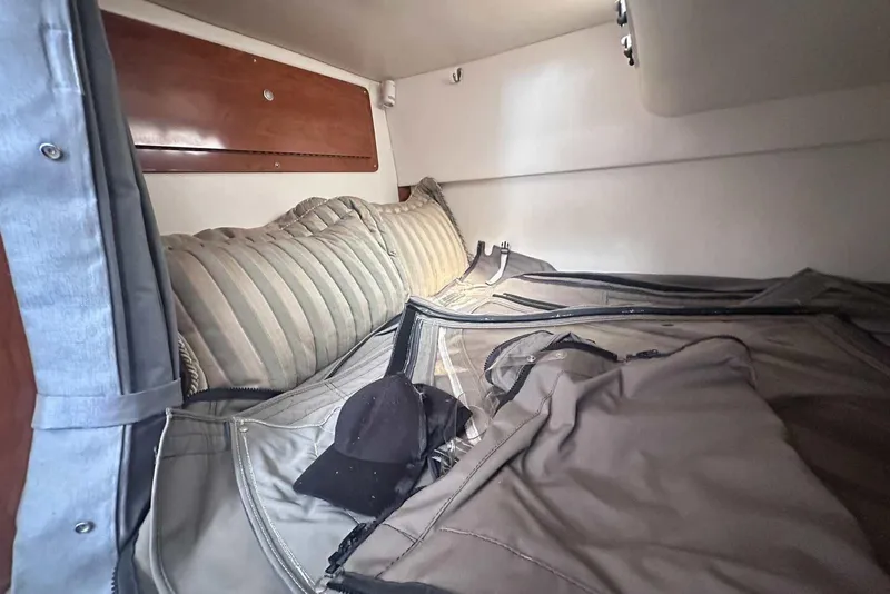 Slide: The Image of Cozy cabin interior of 2004 Four Winns 298 Vista boat with cushions and clothing. - 33