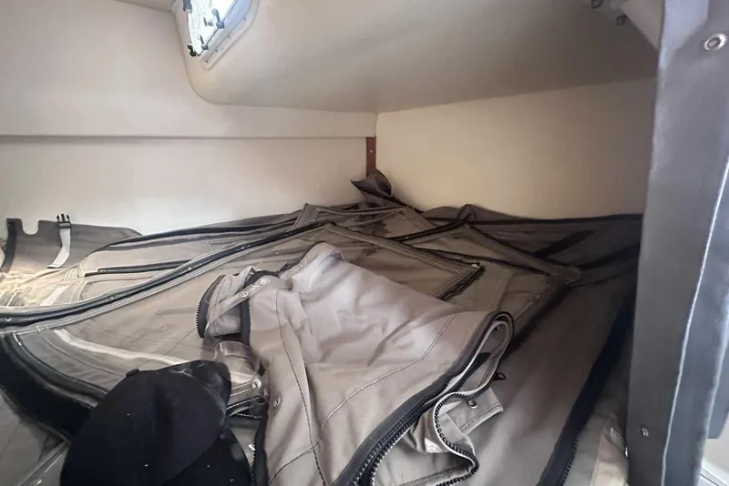 Slide: The Image of 2004 Four Winns 298 Vista cabin interior with folded canvas covers. - 34