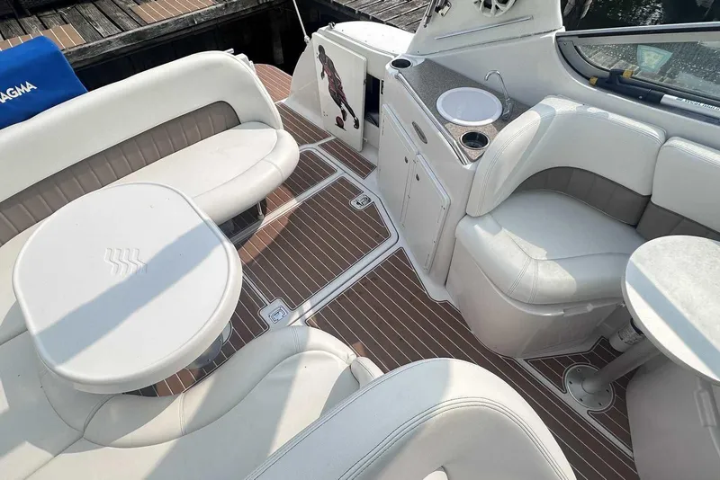 Slide: The Image of 2004 Four Winns 298 Vista boat interior with white seating and wood-style flooring. - 6