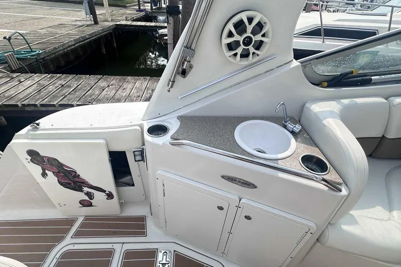 Slide: The Image of 2004 Four Winns 298 Vista boat interior with sink, speaker, and basketball player graphic. - 7
