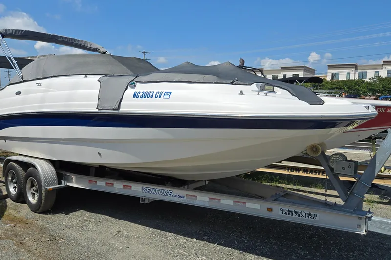 Slide: The Image of 2001 Chaparral Sunesta 233 boat on trailer, covered, parked outdoors. - 0