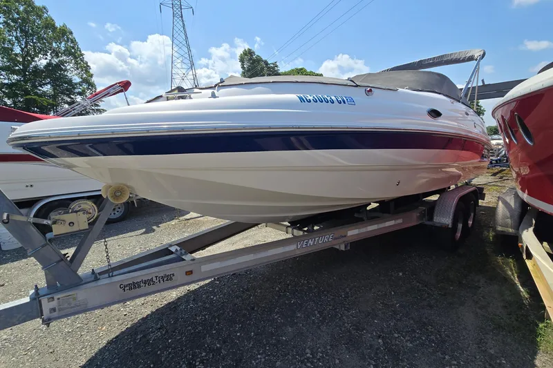 Slide: The Image of 2001 Chaparral Sunesta 233 boat on trailer, parked outdoors under a clear sky. - 1