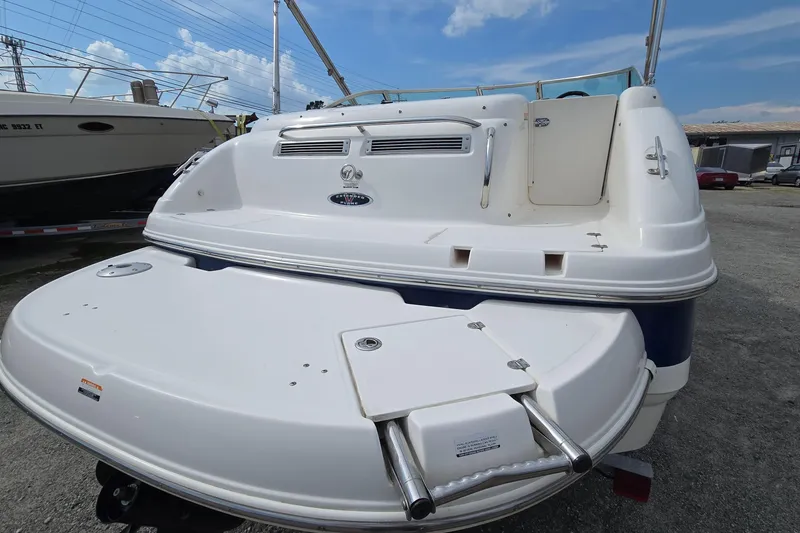 Slide: The Image of 2001 Chaparral Sunesta 233 boat rear view with swim platform and ladder. - 10
