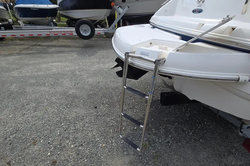 Slide: The Image of 2001 Chaparral Sunesta 233 boat with extended swim ladder on trailer. - 12