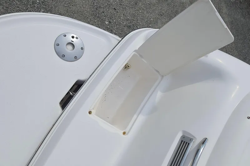 Slide: The Image of 2001 Chaparral Sunesta 233 boat deck with storage compartment and metal fittings. - 13
