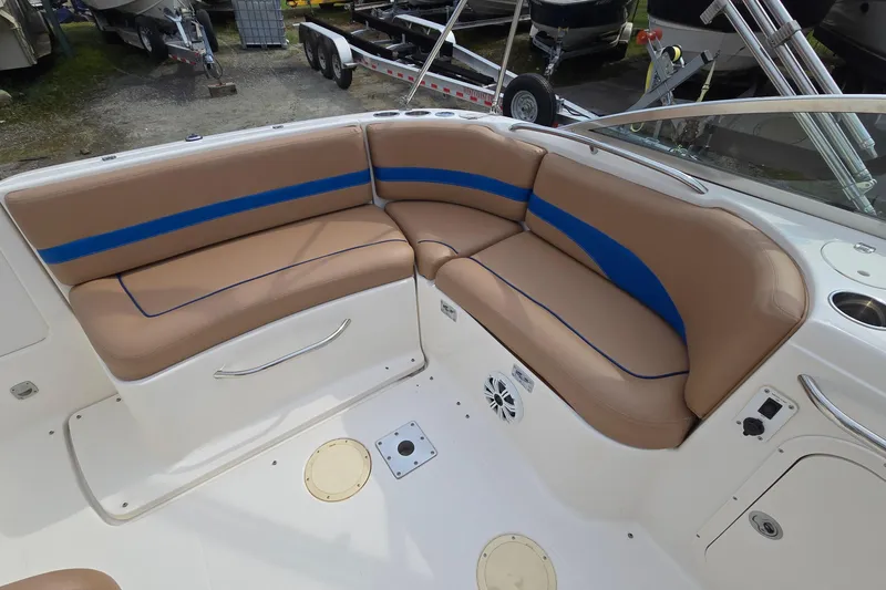 Slide: The Image of 2001 Chaparral Sunesta 233 boat interior with tan and blue seating. - 19