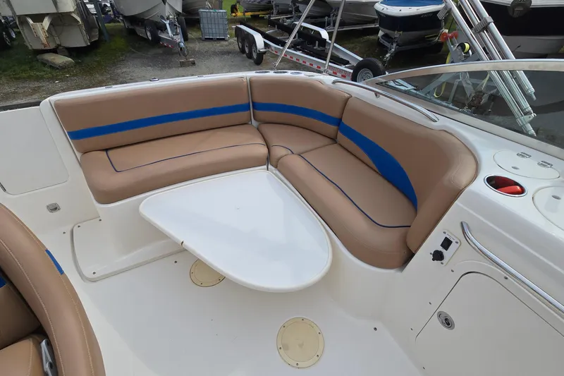 Slide: The Image of 2001 Chaparral Sunesta 233 boat interior with tan and blue seating, white table. - 21