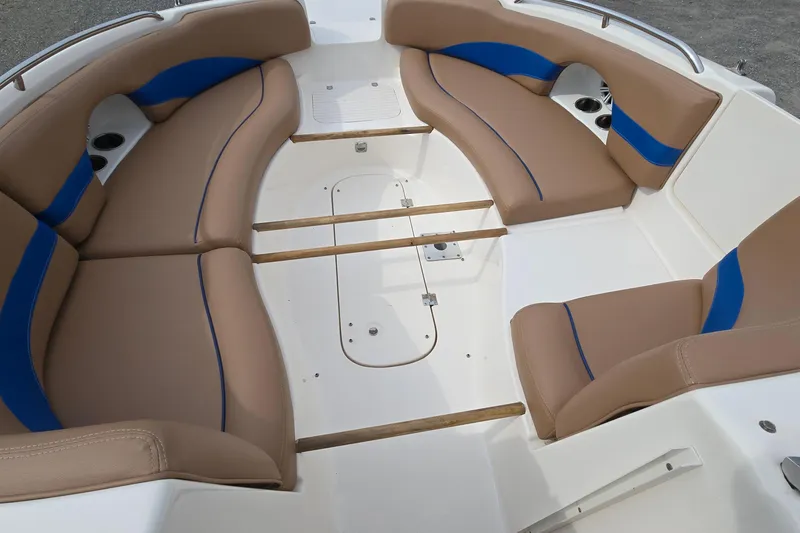 Slide: The Image of 2001 Chaparral Sunesta 233 boat interior with tan and blue seating. - 24