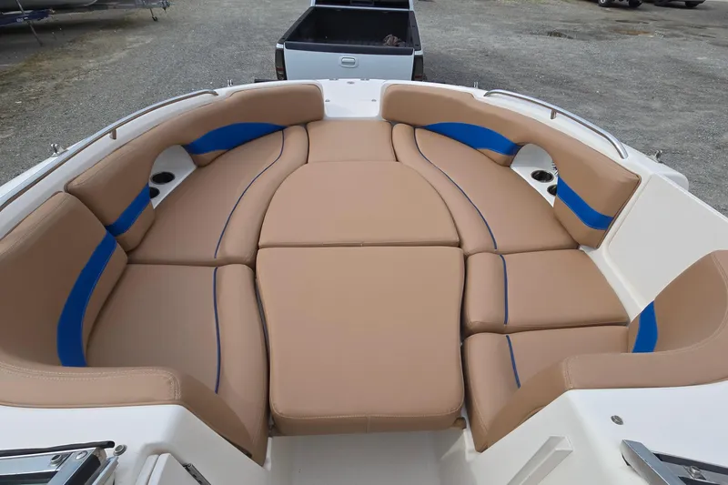 Slide: The Image of 2001 Chaparral Sunesta 233 boat interior with tan and blue cushioned seating. - 25