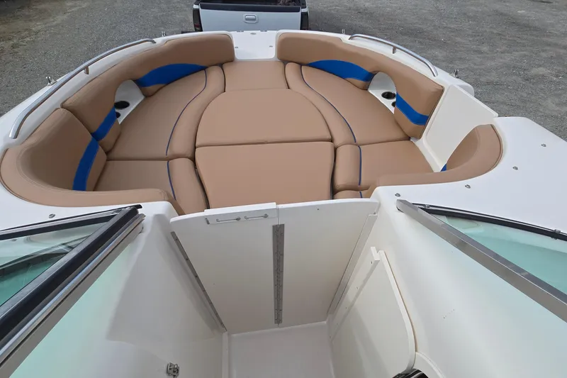 Slide: The Image of 2001 Chaparral Sunesta 233 boat interior with tan and blue cushioned seating. - 26