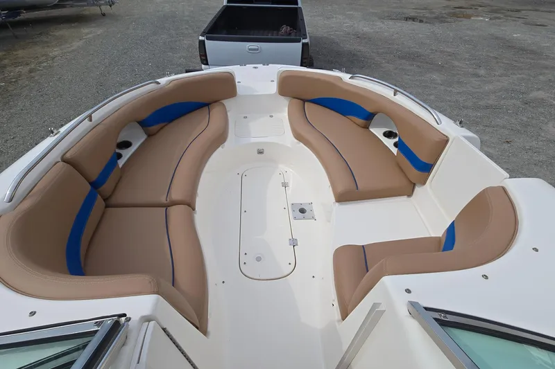 Slide: The Image of 2001 Chaparral Sunesta 233 boat interior with tan and blue seating, spacious layout. - 27