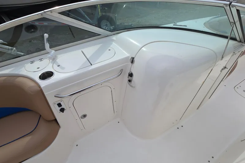 Slide: The Image of 2001 Chaparral Sunesta 233 boat interior with seating and storage compartments. - 28