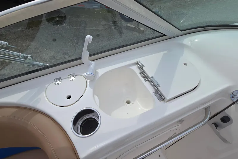 Slide: The Image of 2001 Chaparral Sunesta 233 boat interior with sink and storage compartments. - 29