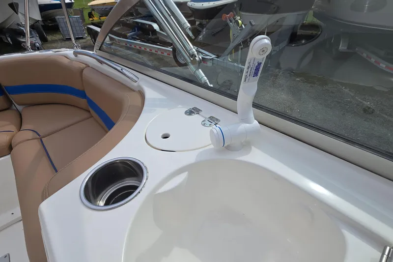 Slide: The Image of 2001 Chaparral Sunesta 233 boat interior with sink, faucet, and seating area. - 30