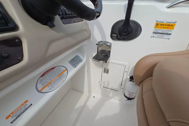 Slide: The Image of 2001 Chaparral Sunesta 233 boat interior with steering wheel, controls, and safety labels. - 35