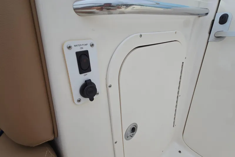 Slide: The Image of 2001 Chaparral Sunesta 233 boat water pump switch and compartment door. - 37
