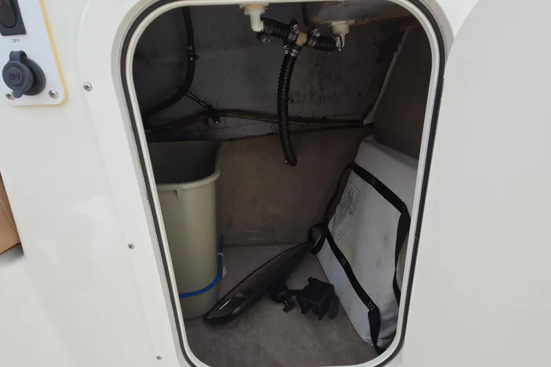 Slide: The Image of Storage compartment of 2001 Chaparral Sunesta 233 boat with various items inside. - 38