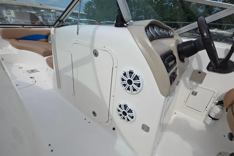Slide: The Image of 2001 Chaparral Sunesta 233 boat interior with dashboard, speakers, and seating. - 41