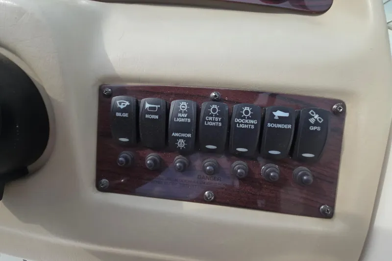 Slide: The Image of Control panel of a 2001 Chaparral Sunesta 233 boat with various switches. - 43