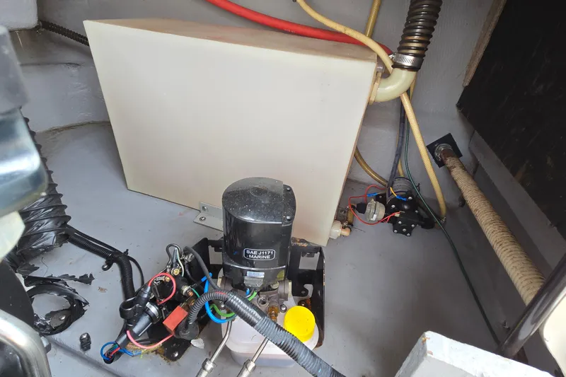 Slide: The Image of 2001 Chaparral Sunesta 233 boat engine compartment with wiring and components. - 48